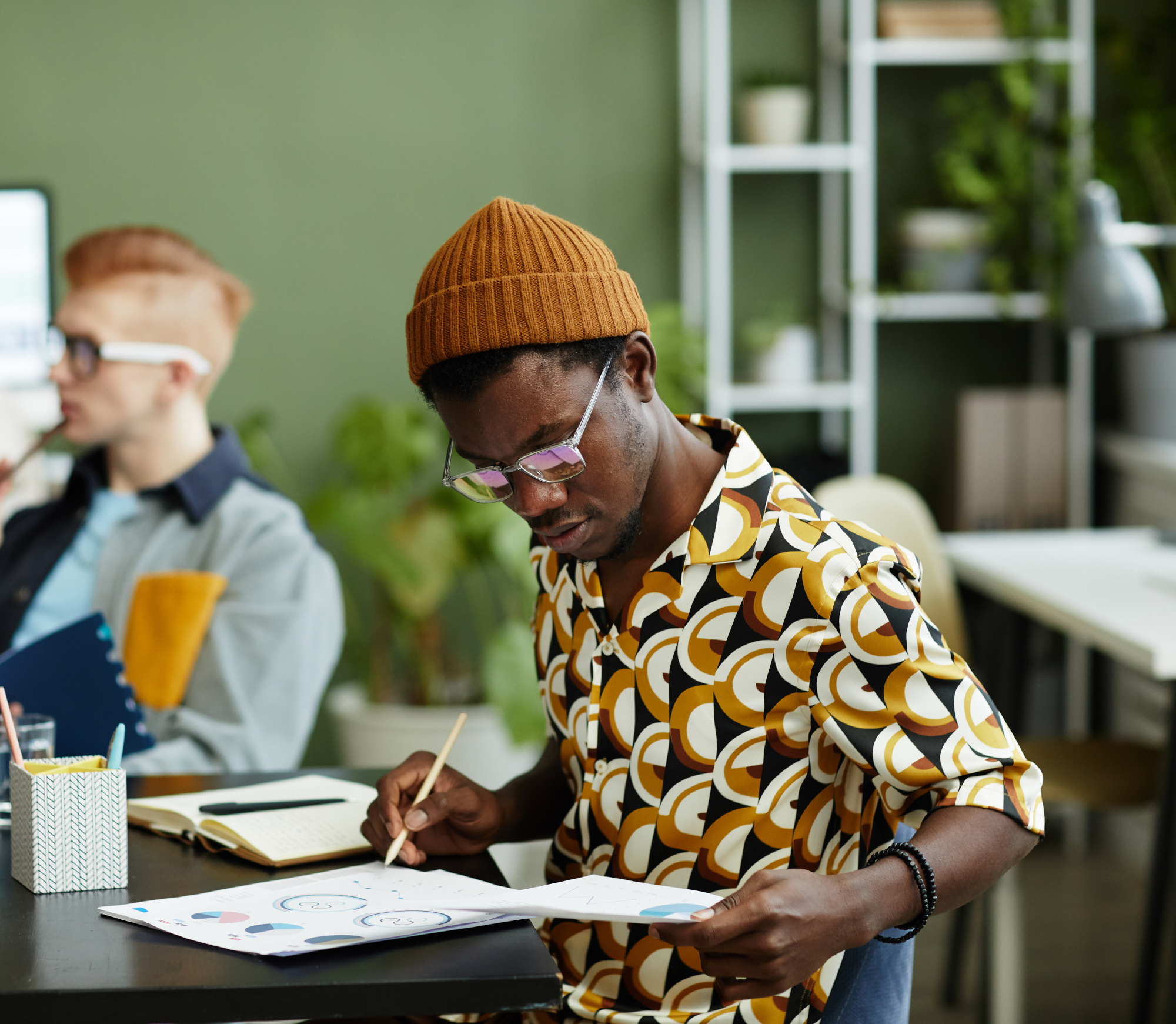 Side view portrait of creative African American man analyzing data report in business meeting, copy space